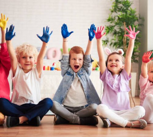 Group of children with colorful, painted hands Group of children with colorful, painted hands