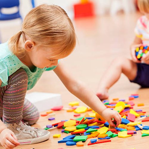 istockphoto-598560056-612x612 Two sweet Caucasian toddler girls playing with puzzle pieces on the floor of their preschool classroom. The puzzle pieces are colorful and the preschoolers are focused on the task at hand.