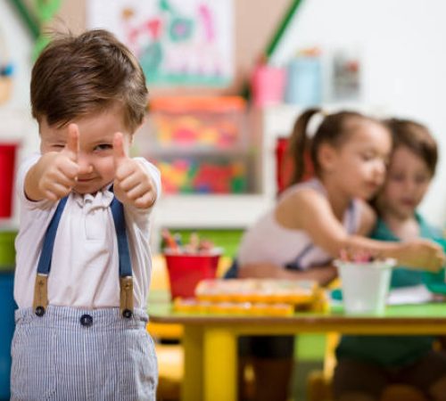 Happy little boy posing in classroom. Happy little boy posing in classroom.